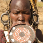 Why Girls Of The Mursi Tribe Must Remove Their Teeth And Stretch Their Lips Before They Marry