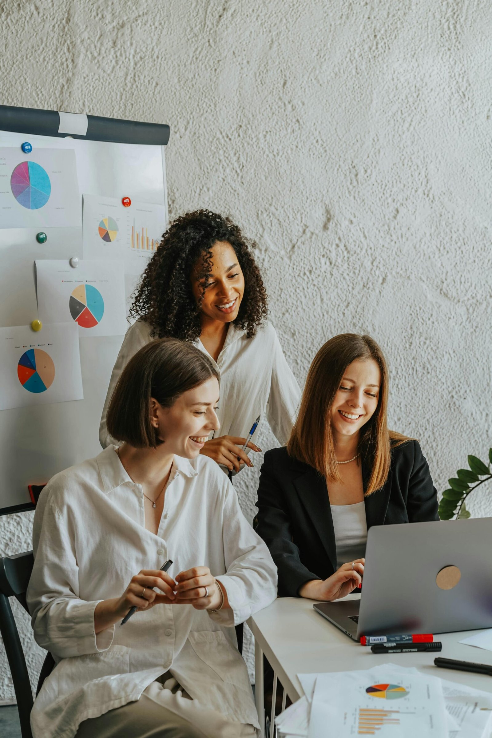Group of women holding devices to discuss tech vulnerabilities