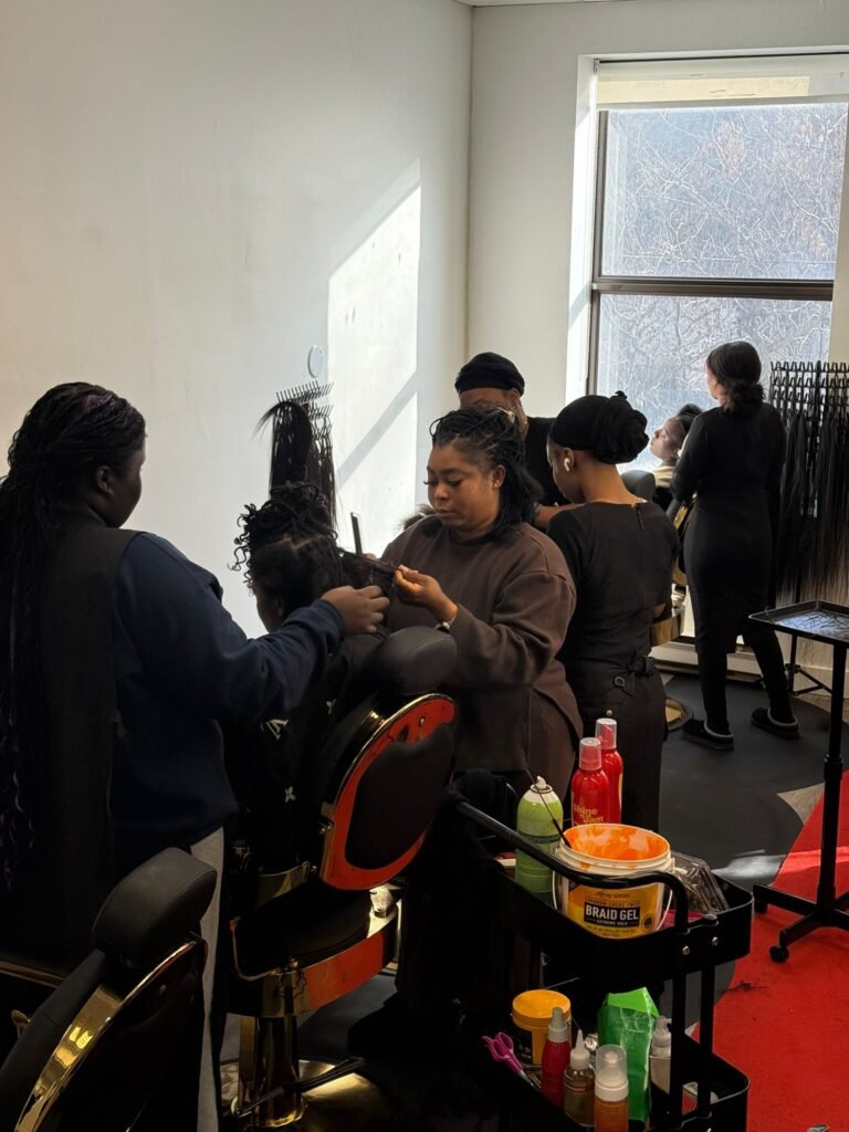 Mawusinu Jennifer Hodgson braiding a client's hair at Passionate Hands 24/7, Toronto's first viral 24-hour braiding salon.